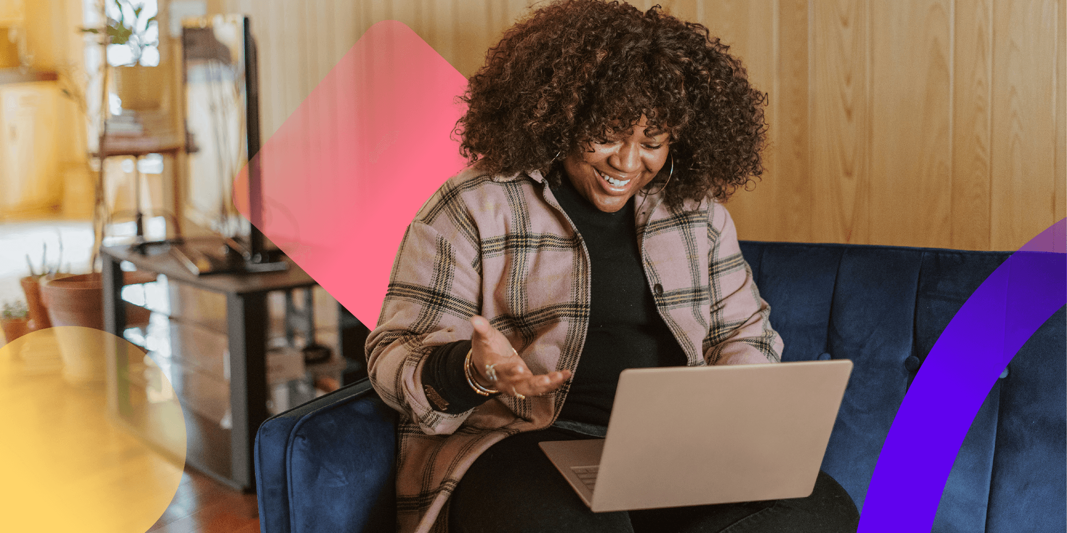 A woman is sitting at a laptop working on an internal comms calendar.